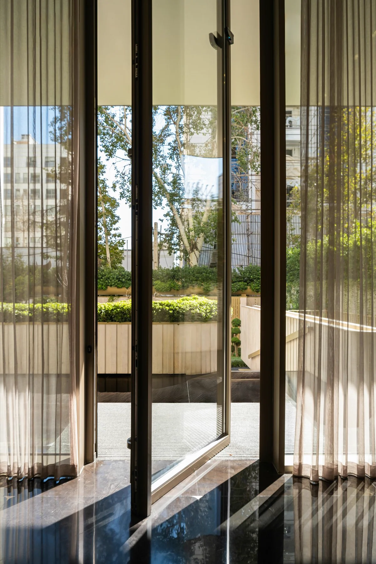 Interior view through bifold doors to sunny garden