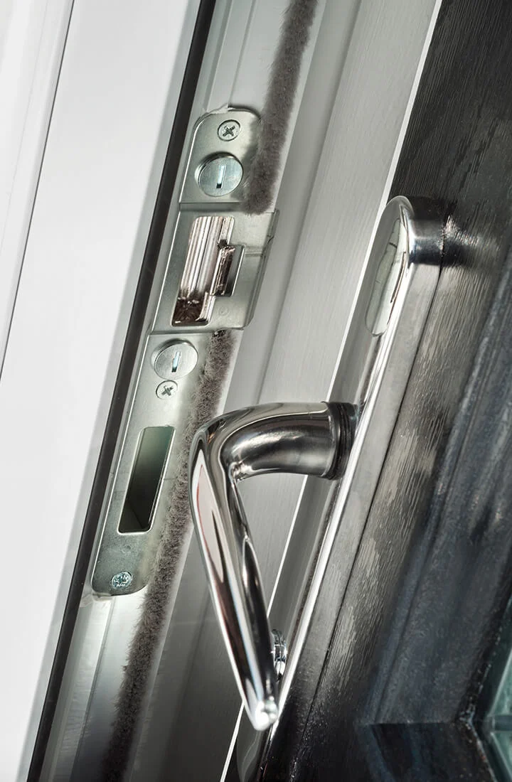 Premium composite door close-up showing woodgrain finish and security lock